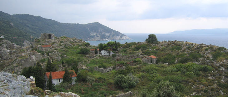 The ruins of Old Schiatto and beyond them the channel between the island and mainland Greece